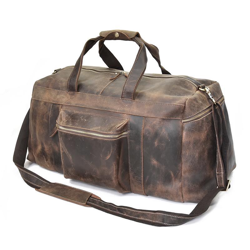 Brown leather duffle bag with dual front zip pockets and adjustable shoulder strap.