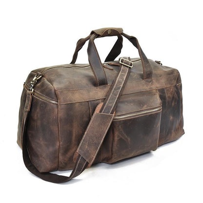 Brown leather weekender duffle with side zip pockets, crossbody strap, and top handle.