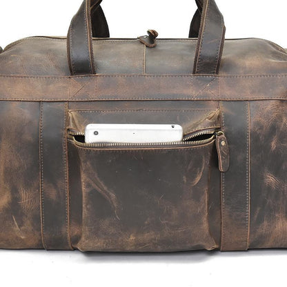 Distressed dark brown leather duffle bag front pocket with zipper and leather tab pull