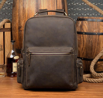 Vintage leather backpack with top handle, front zipper pocket, adjustable straps