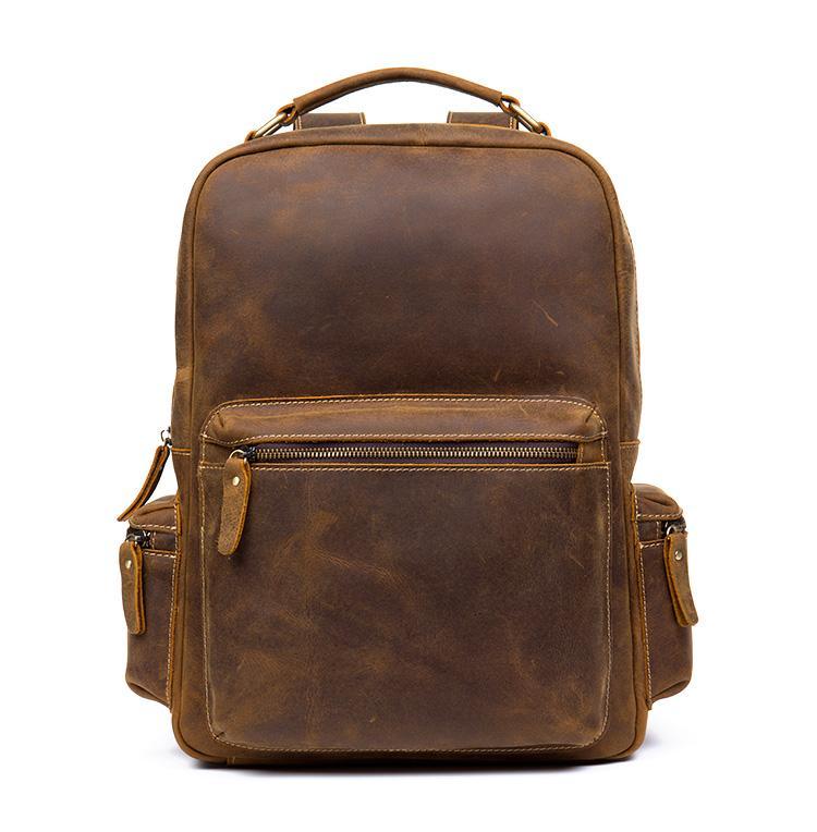Brown leather vintage backpack front view with zipper pocket and side strap tabs