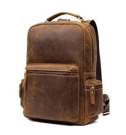 Brown vintage leather backpack with front zip pocket, side accessory pocket, and top handle.