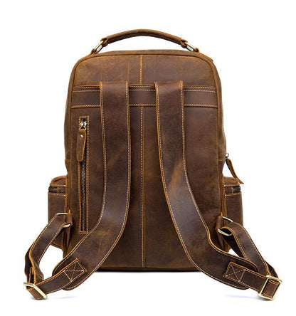 Brown leather vintage backpack with top handle, front pockets, and adjustable straps