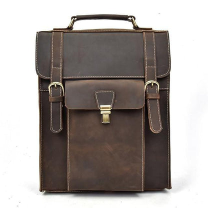 Dark brown vintage leather backpack with top handle, front flap, and metal buckle latch