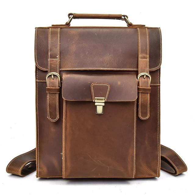 Brown vintage leather backpack front view with top handle, flap latch, and side buckles
