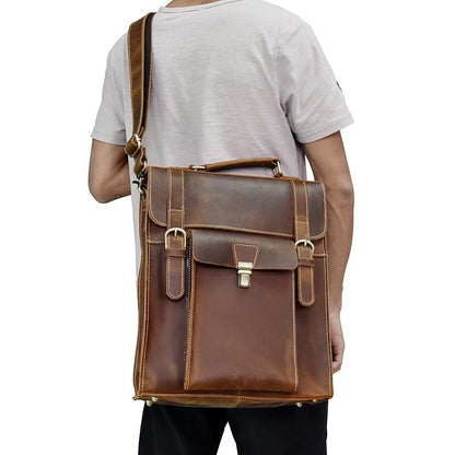 Brown leather backpack side view with front flap, two straps, and small front pocket