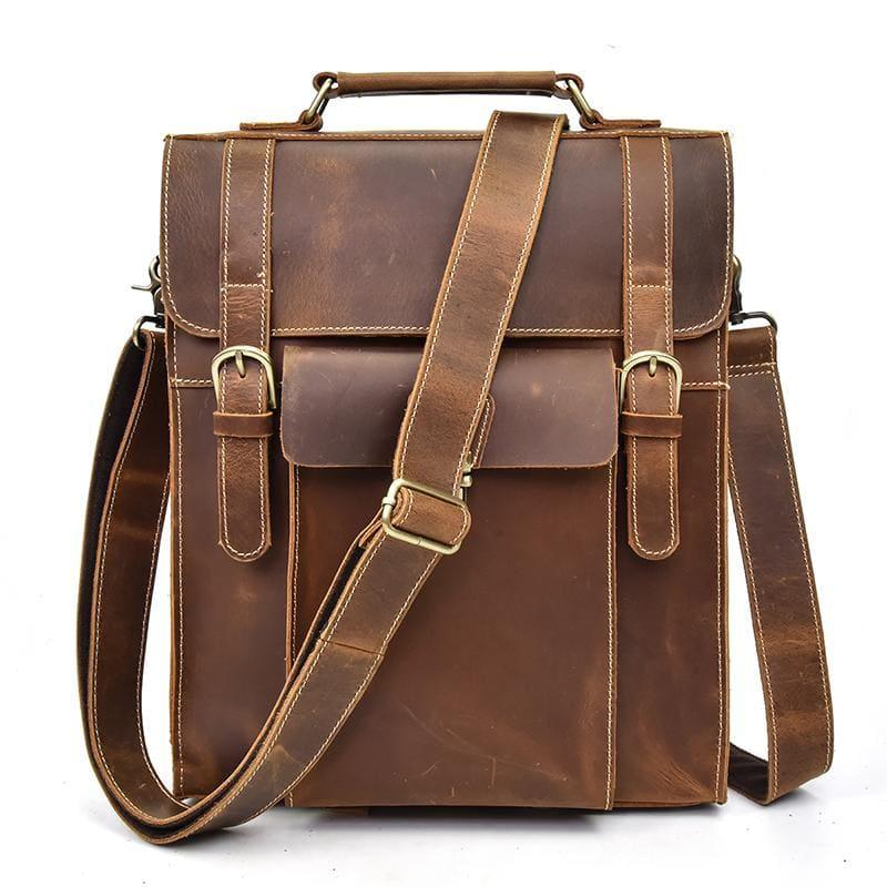 Brown vintage leather backpack with top handle, front flap, buckle closure, and side straps