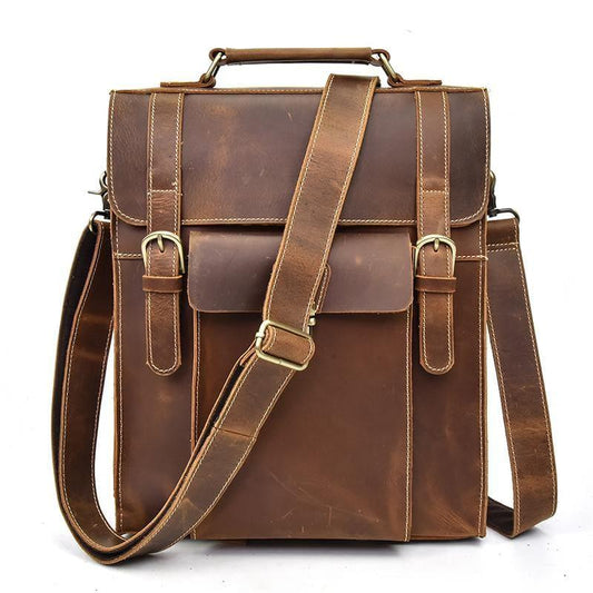 Brown vintage leather backpack with top handle, front flap, buckle closure, and side straps