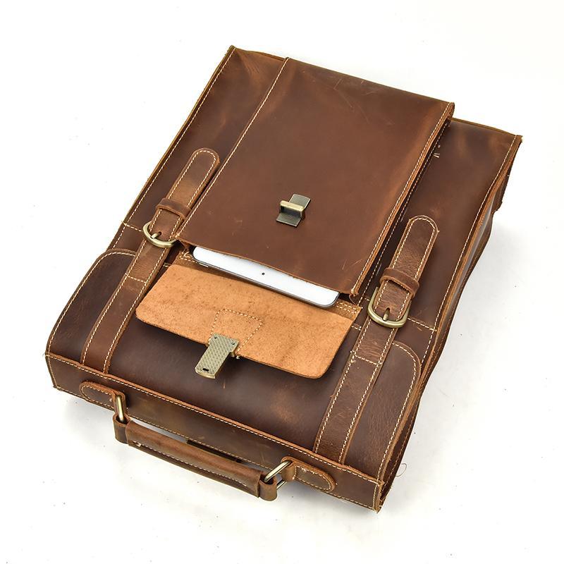 Vintage leather backpack open view with front compartments, buckles, and strap hardware