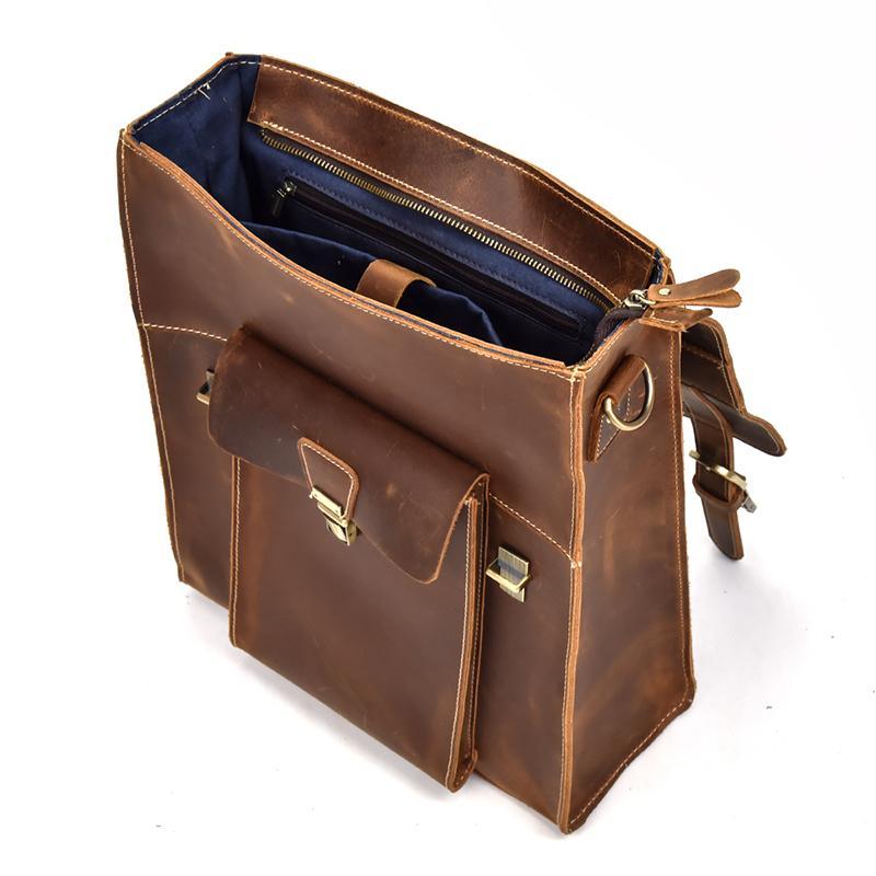 Brown leather backpack open view with interior pockets and zip closure
