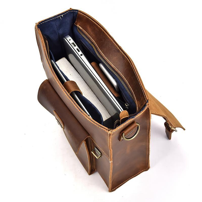 Brown leather backpack open top showing interior compartments and zip pocket