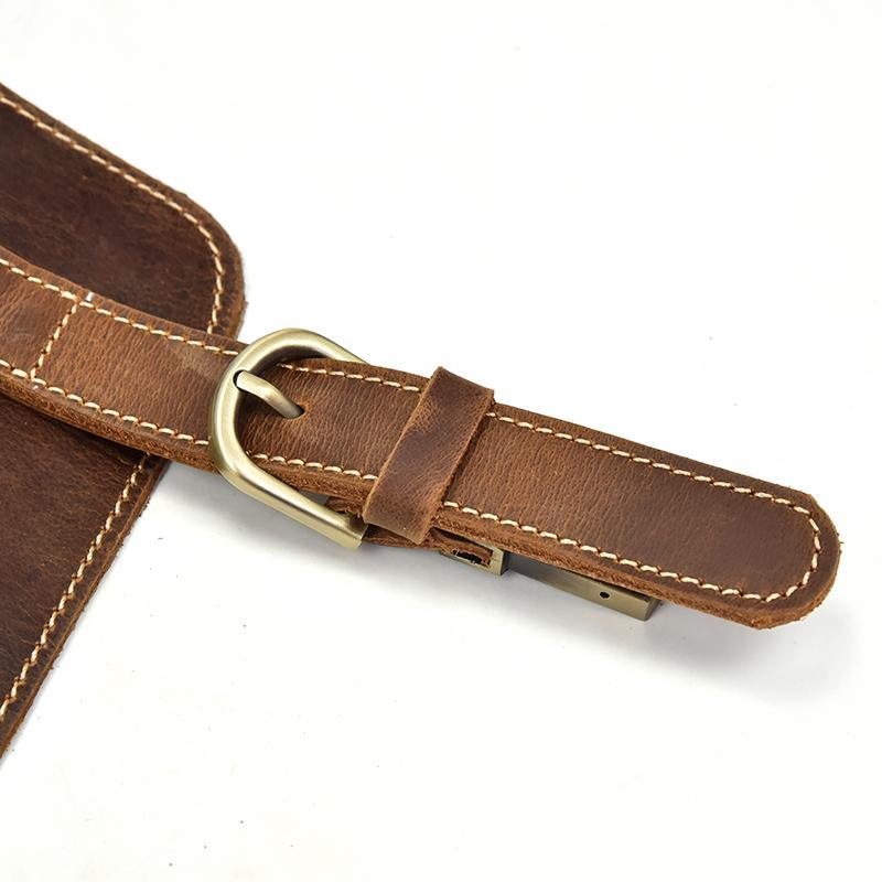 Leather backpack strap with brass D-ring and stitched edge detail