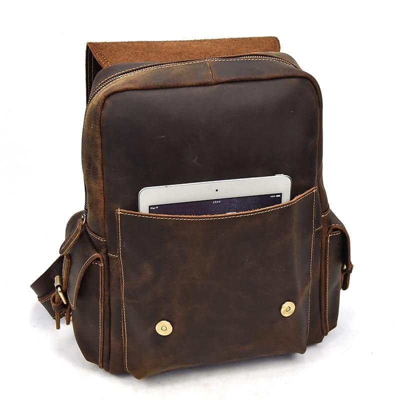 Brown leather backpack with front zip pocket and inner sleeve for a tablet