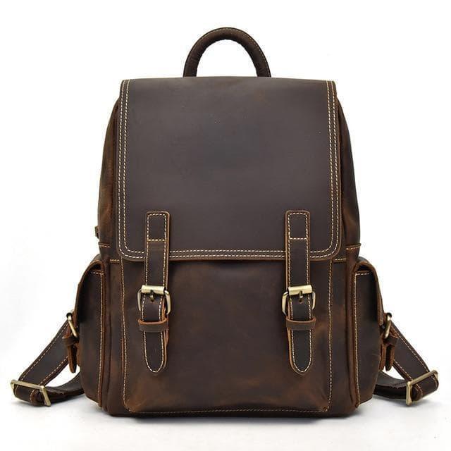 Brown leather backpack with flap front, buckles, and adjustable shoulder straps