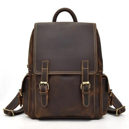 Brown leather backpack with flap front, buckles, and adjustable shoulder straps