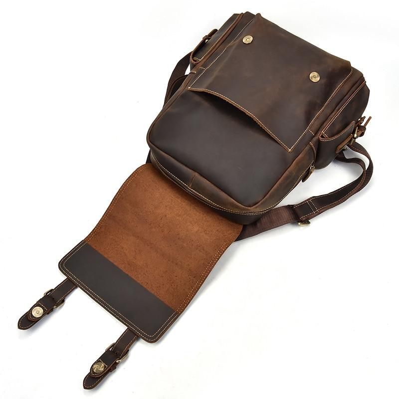 Brown leather backpack with flap top, brass hardware, and adjustable shoulder strap