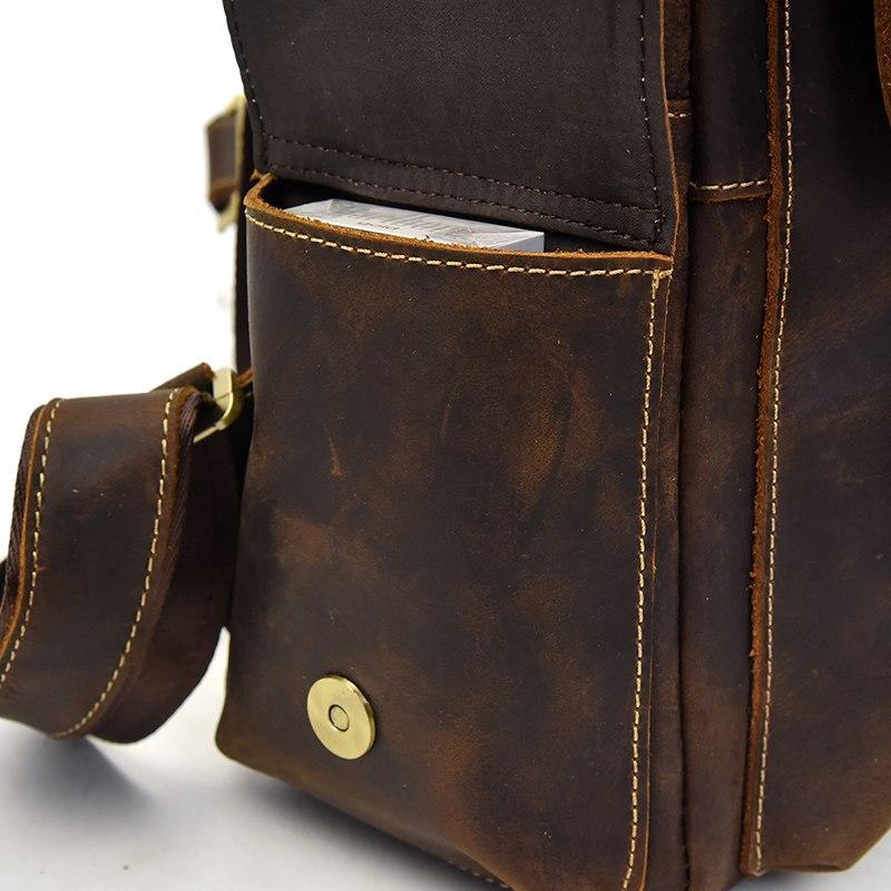 Leather backpack side panel with zipper, stitched trim, and brass snap button