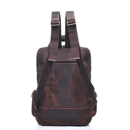 Brown leather backpack with two back straps and rear panel pocket.