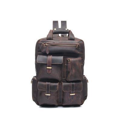 Brown leather backpack with top handle, two front flap pockets, buckle details.