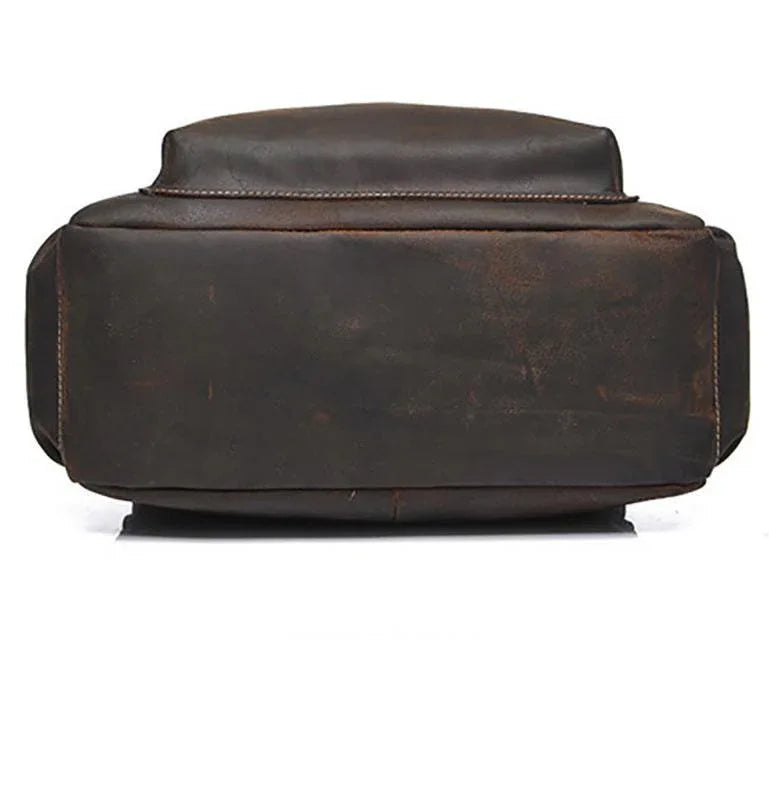 Vintage leather laptop backpack, rear view with padded top handle.