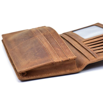 Brown leather pocket book open, showing stitched card compartments and lining