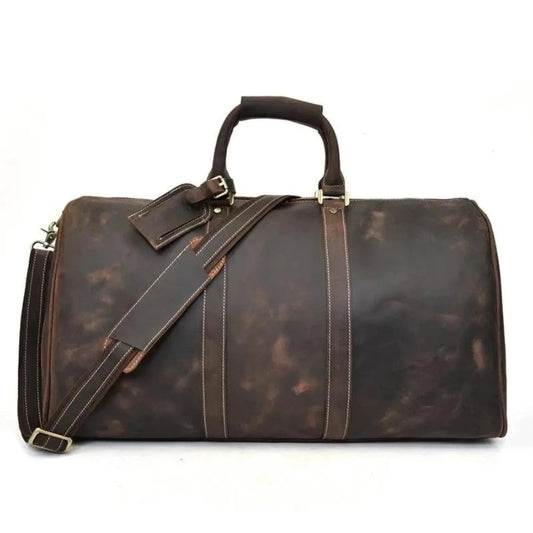 Dark brown leather duffel bag with adjustable shoulder strap and stitched panels