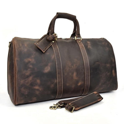 Dark brown leather duffle bag with top handles, stitched straps, and front leather tag.