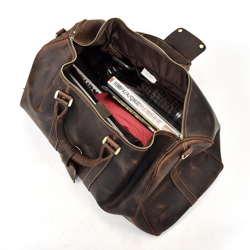 Brown leather duffel bag interior with zip lining, pockets, and brass hardware