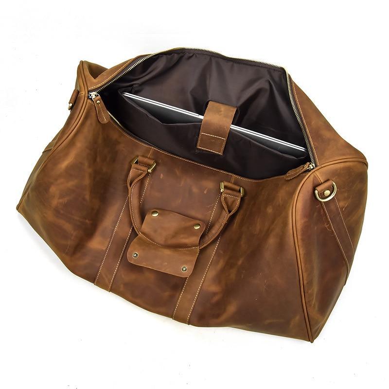 Brown leather duffle bag open top with interior lining, inner pocket, and zip closure.
