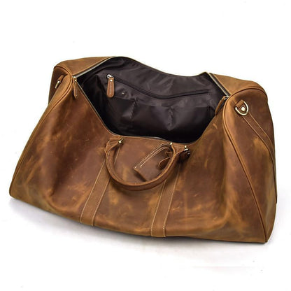 Brown leather duffle bag with zipper top, stitched panels, and front pocket.