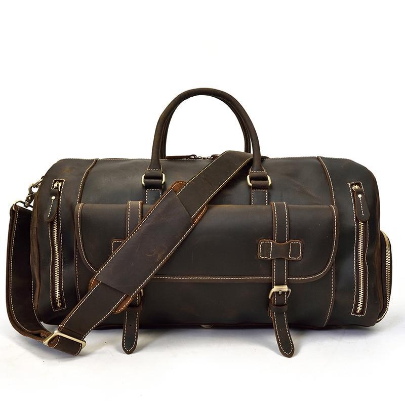 Handmade leather duffle bag in dark brown with crossbody strap, buckle front, zip pockets