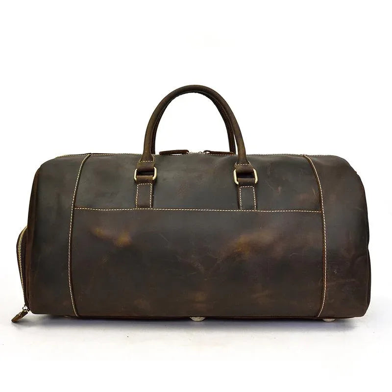 Handmade leather duffle bag in dark brown, top handles, front buckle strap, side zippers
