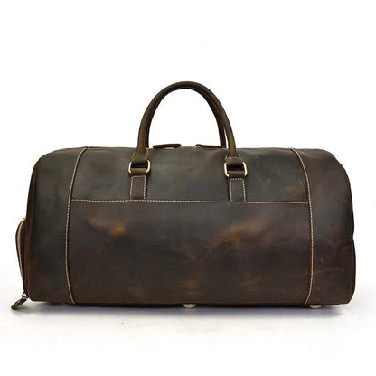 Handmade leather duffle bag in dark brown, top handles, front buckle strap, side zippers