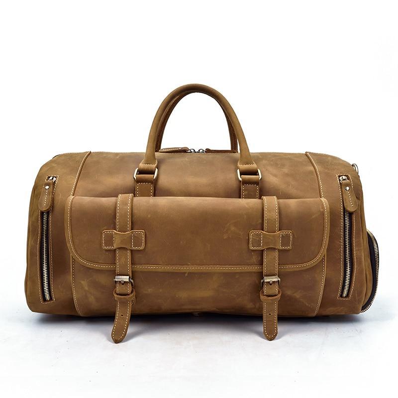 Handmade leather duffle bag in brown, top handles, front buckle strap, side zipper pockets