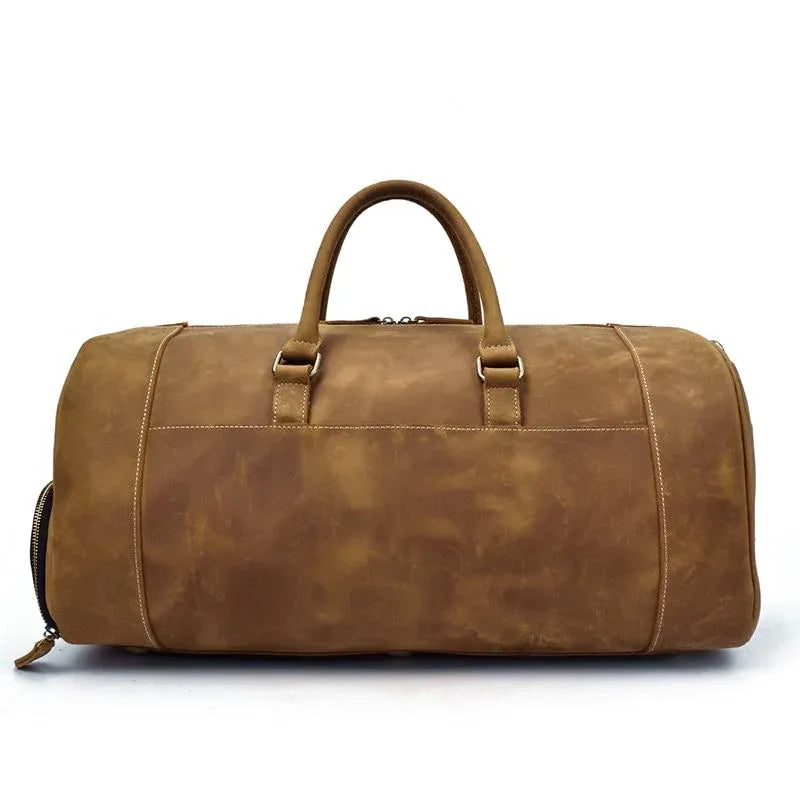 Handmade leather duffle bag in brown, top handles, front strap panel, side zip pockets