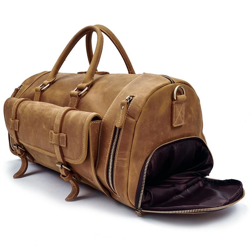 Handmade leather duffle bag in tan brown with open zip top, dark interior lining visible