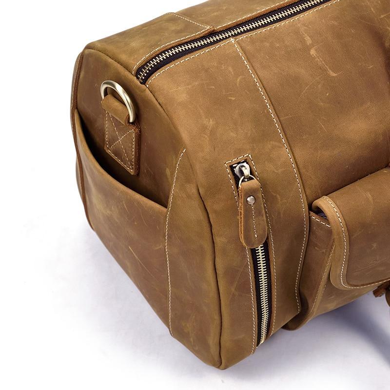 Handmade leather duffle bag in dark brown with side buckle strap and zipper pocket