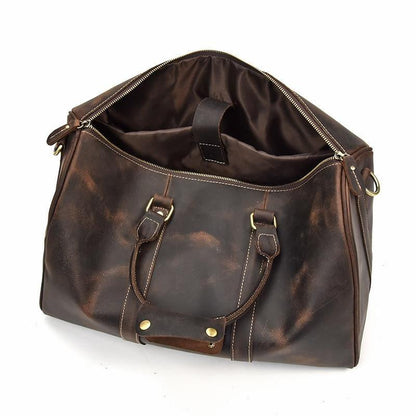 Small dark leather duffle bag with open top, interior pocket, and gold-tone hardware