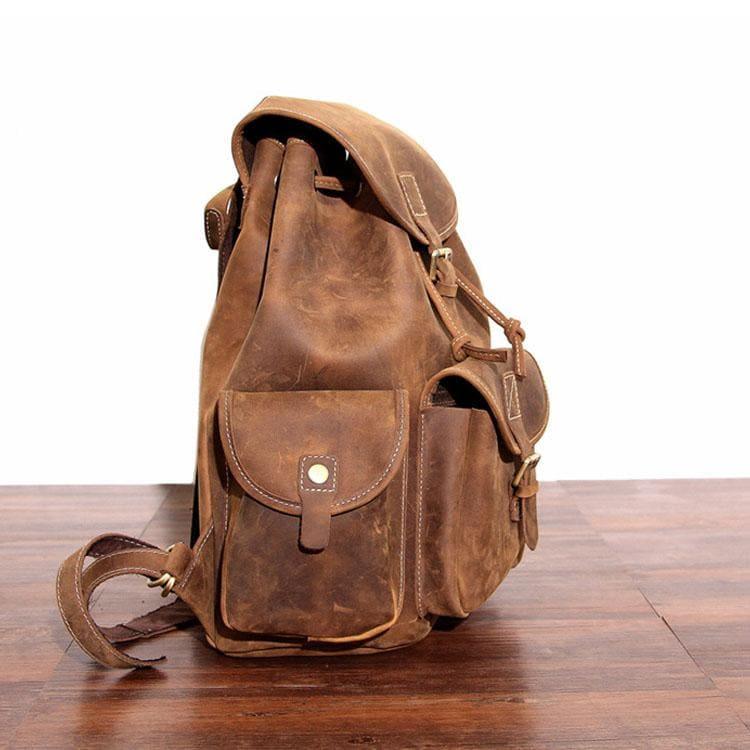 Brown leather rucksack with front organizer pocket and flap strap closure