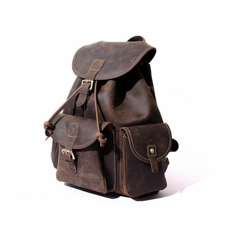 Dark brown leather rucksack with multiple front pouches and flap top buckle straps