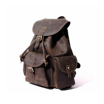 Dark brown leather rucksack with multiple front pouches and flap top buckle straps