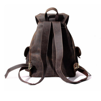 Dark brown leather rucksack with top handle, shoulder straps, and side carry loops