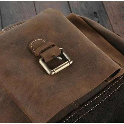 Leather rucksack close-up showing metal buckle and stitched keeper strap
