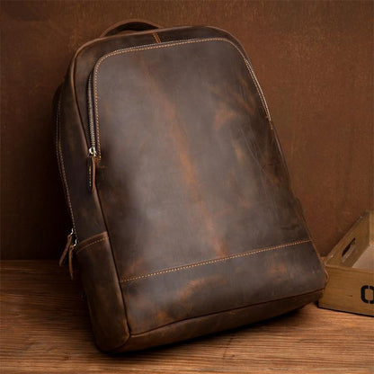 Vintage leather minimalist backpack side angle with front seam and dark brown patina