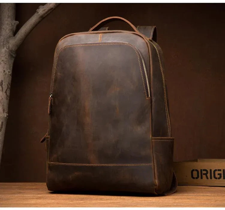 Vintage brown leather backpack with front zipper track and side pocket