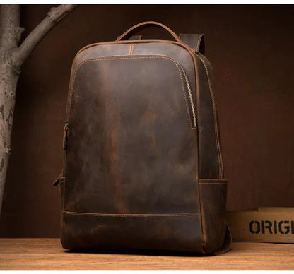 Vintage brown leather backpack with front zipper track and side pocket