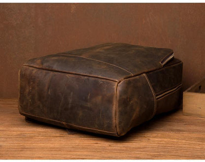 Vintage brown leather backpack with structured base and side carry handle