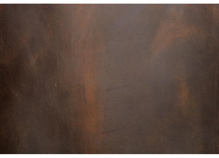Vintage leather backpack panel detail with distressed brown finish