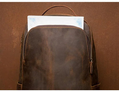 Vintage brown leather backpack with zippered top and arched handle