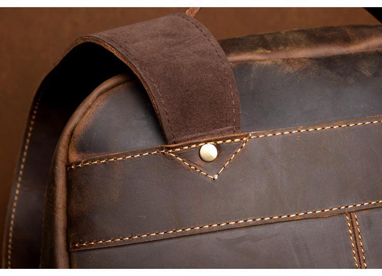 Vintage leather backpack shoulder strap detail with rivets and contrast stitching